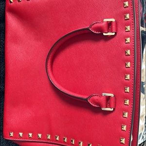 Michael Kors satchel Ruby red with gold accents. Brand new condition. Beautiful